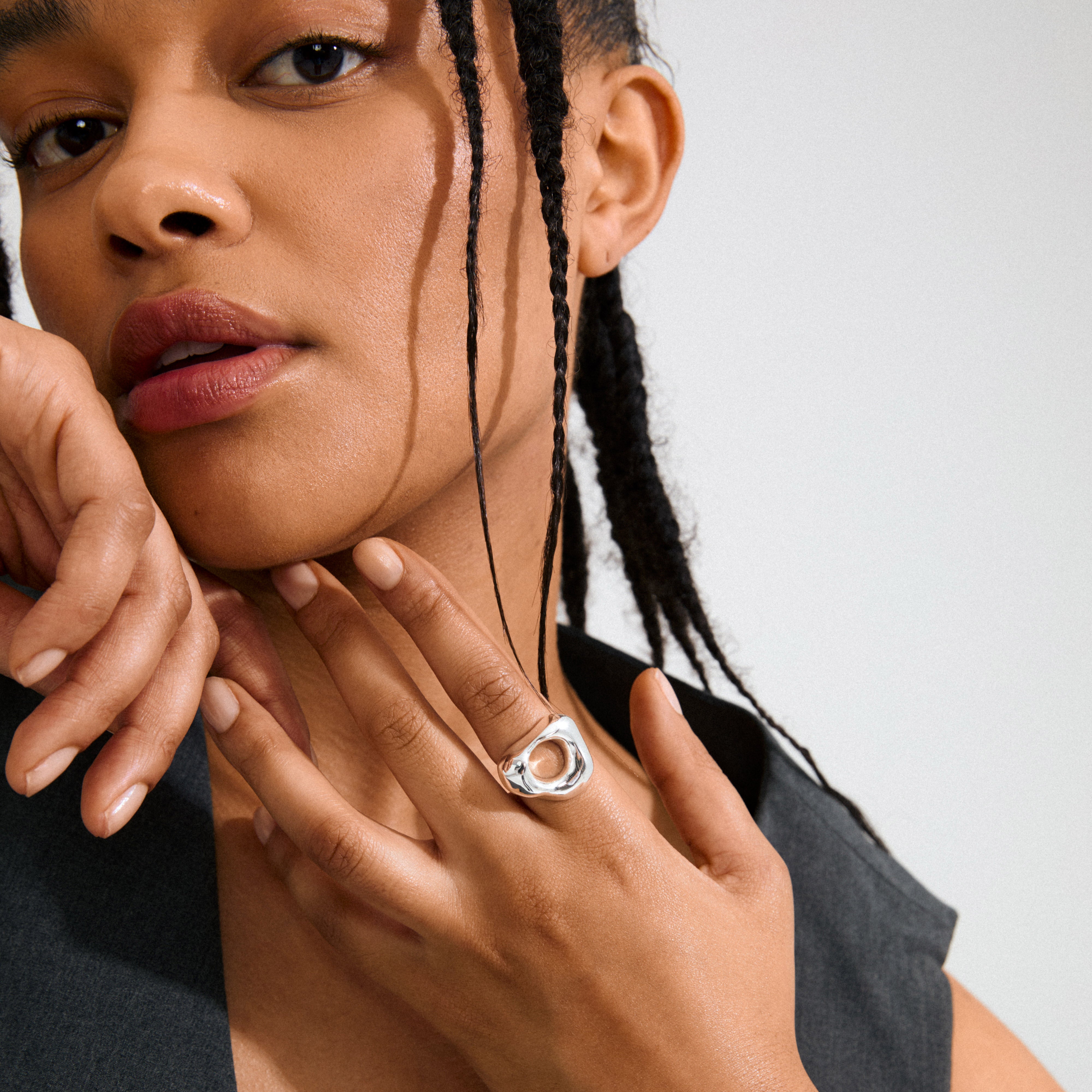 Close-up of a young woman wearing Pilgrim's FREE silver-plated ring, featuring an open-circle design, highlighting its sculptural elegance and urban flair.